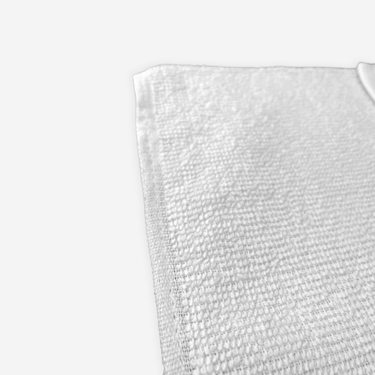 Close up view on the corner of a white cleaning towel.