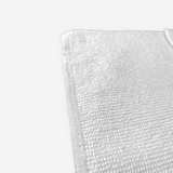 Close up view on the corner of a white cleaning towel.