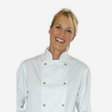 Blond women wearing a white chef coat for the food service industry.
