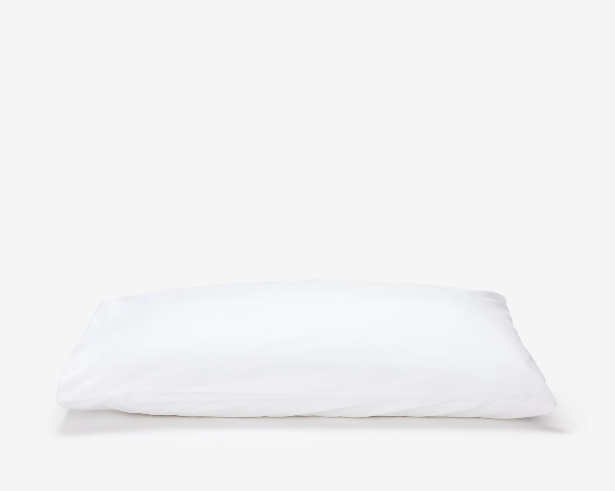 White hotel pillow featuring a white pillow protector with flap.