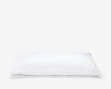 White hotel pillow featuring a white pillow protector with flap.