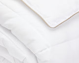 Close up view on a white hotel duvet folded.