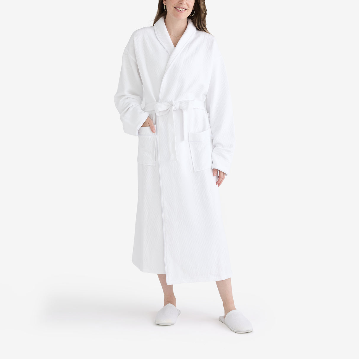 Women wearing a white hotel bathrobe and slippers