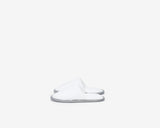 White closed toe kids slippers with a grey sole.