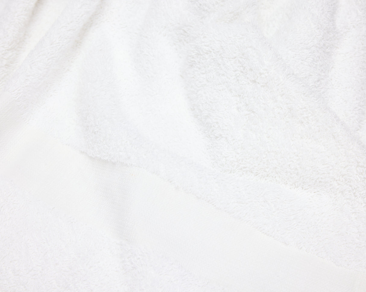 close up view of a white hotel towel.