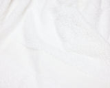 close up view of a white hotel towel.