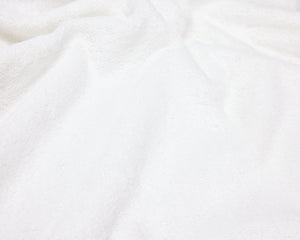 Close up view of a white hotel towel.