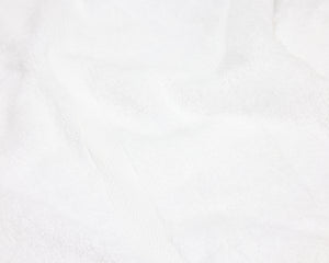 Close up view of a white hotel towel.